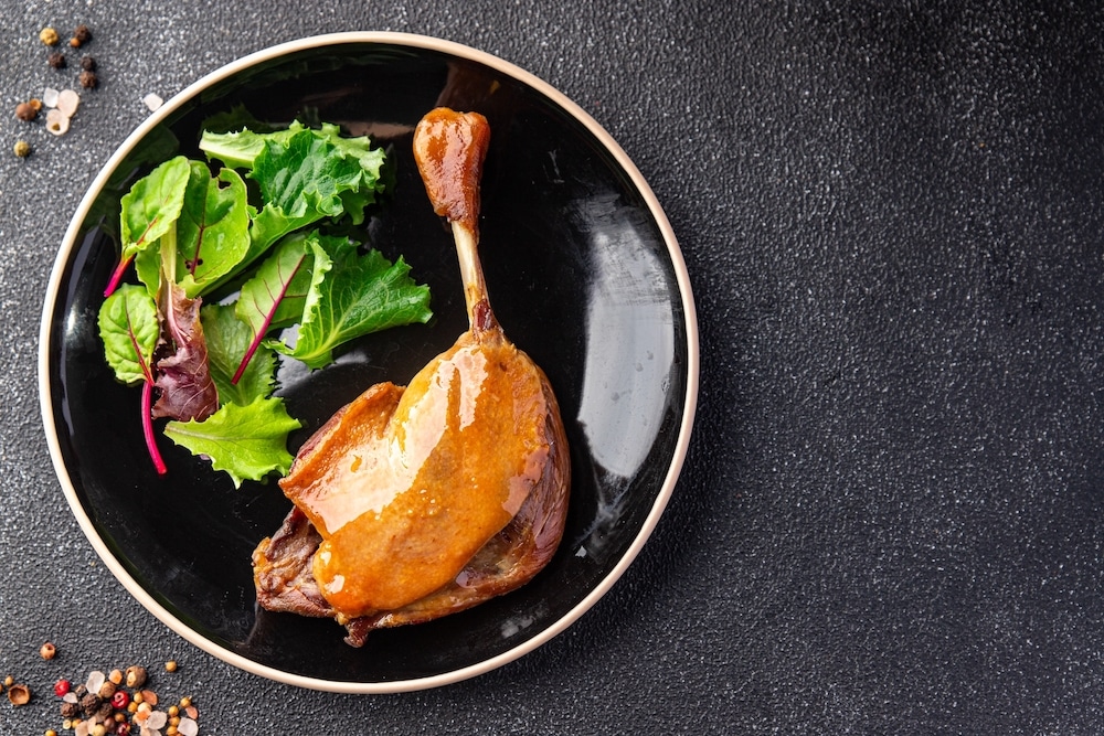 duck confit leg, red berry sauce meal food snack on the table copy space food background